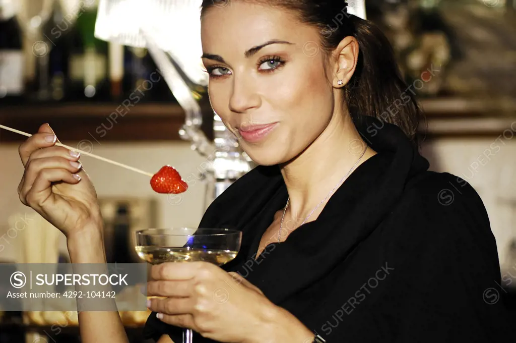 Woman having champagne with strawberry