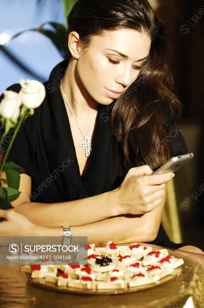 Woman with mobile in a cafe
