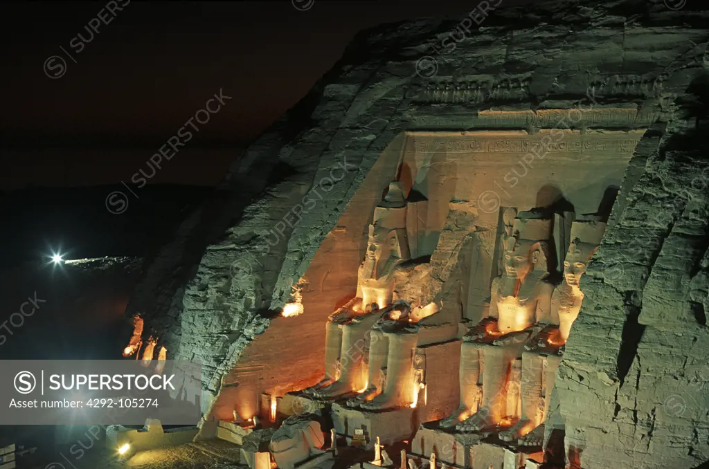 Egypt - Abu Simbel, Great Temple of Rameses II, one of the four statues of Ramesses II at the temple's gate at night
