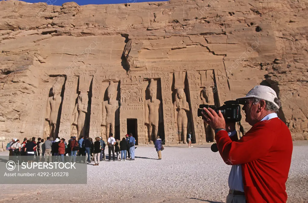 Egypt, Abu Simbel, tourist filming the temple of Nefertari dedicated to Hathor