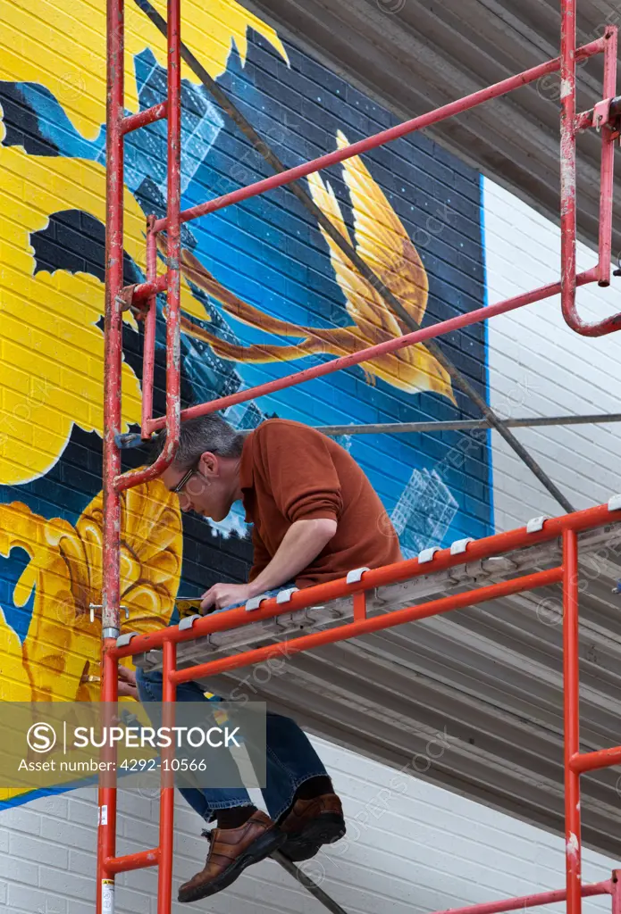 USA, Oklahoma, Tulsa, painter working on building on Route 66