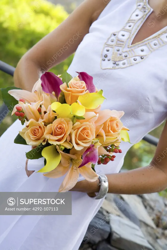 Close-up of bride holding wedding bouquet