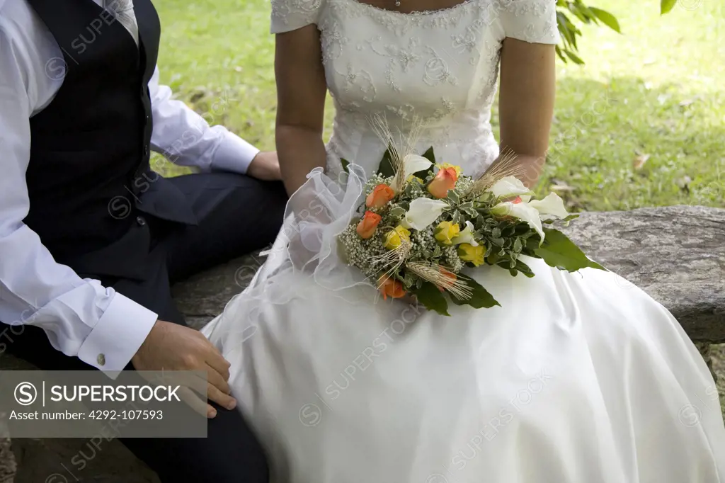 Bride and groom sitting outdoor