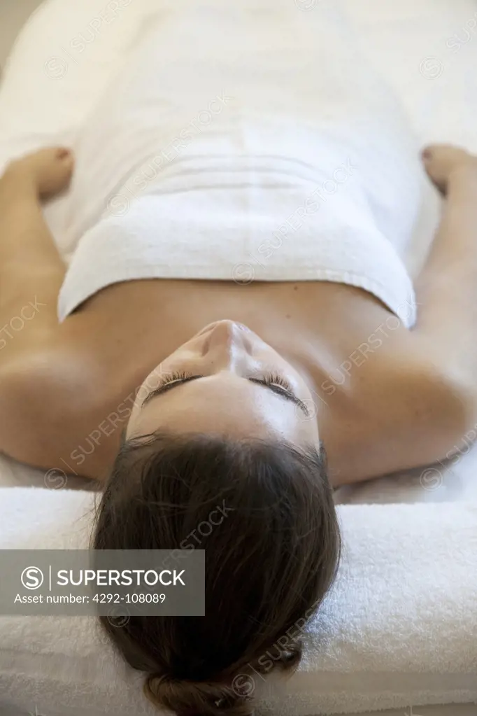 Woman at spa lying on massage table
