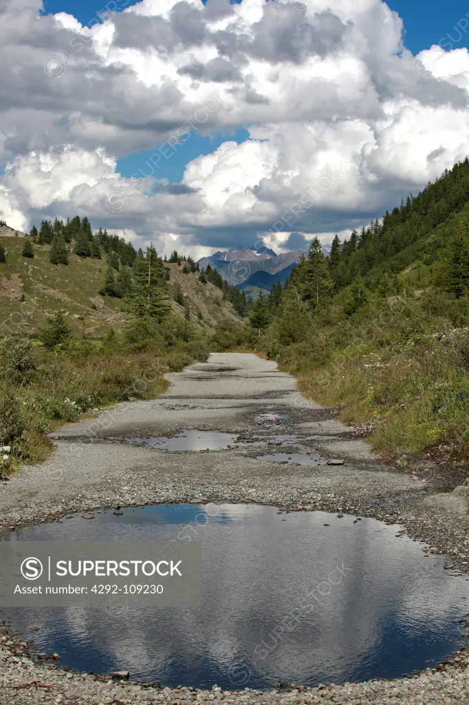 Italy, Alps, view of the Mont Blanc chain, water pools in road