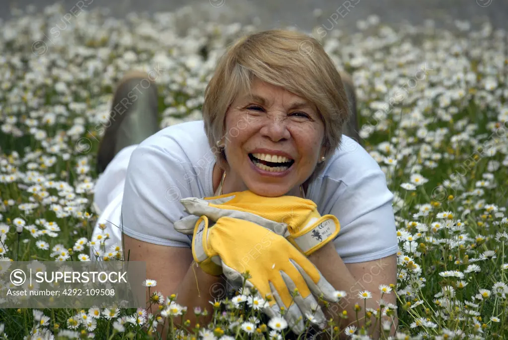 Senior woman lying on meadow