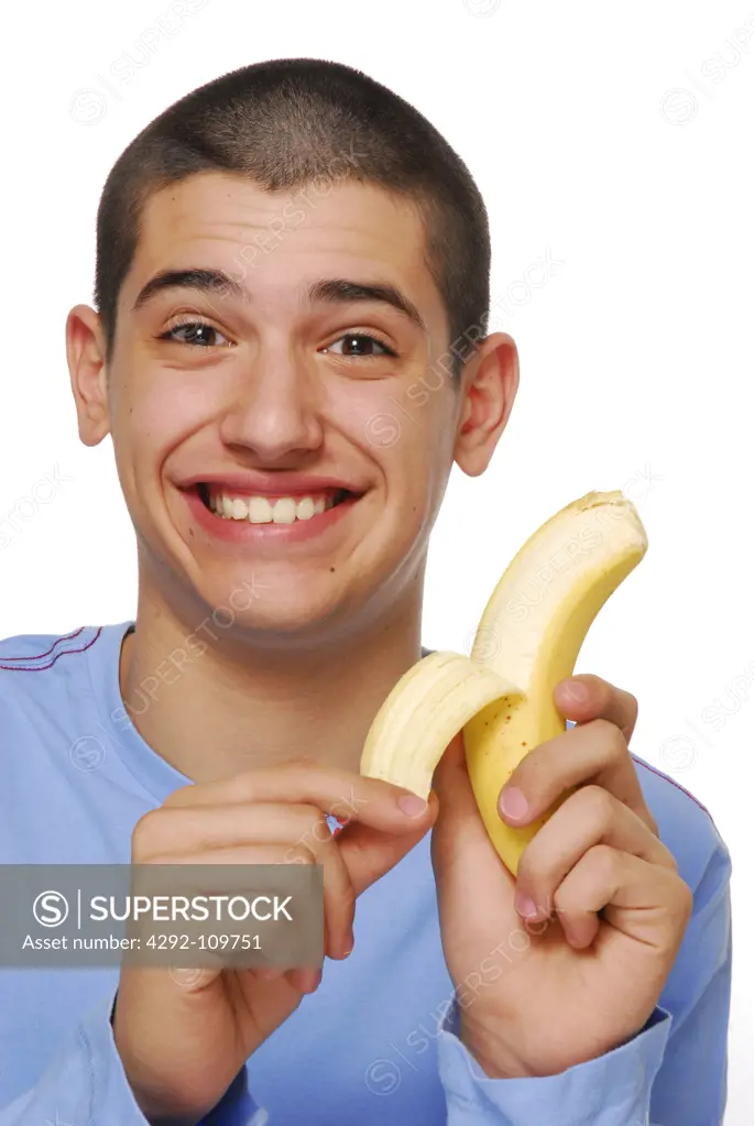 Teenage boy holding a banana