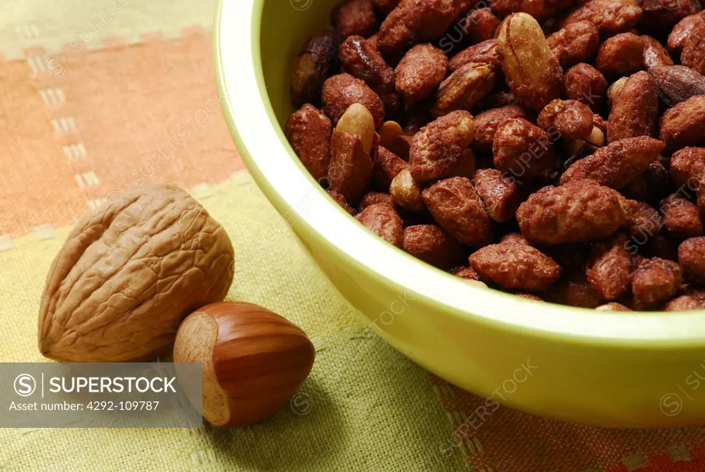 Bowl of roasted hazelnuts and walnuts
