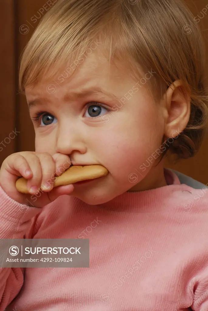 Girl eating a biscuit