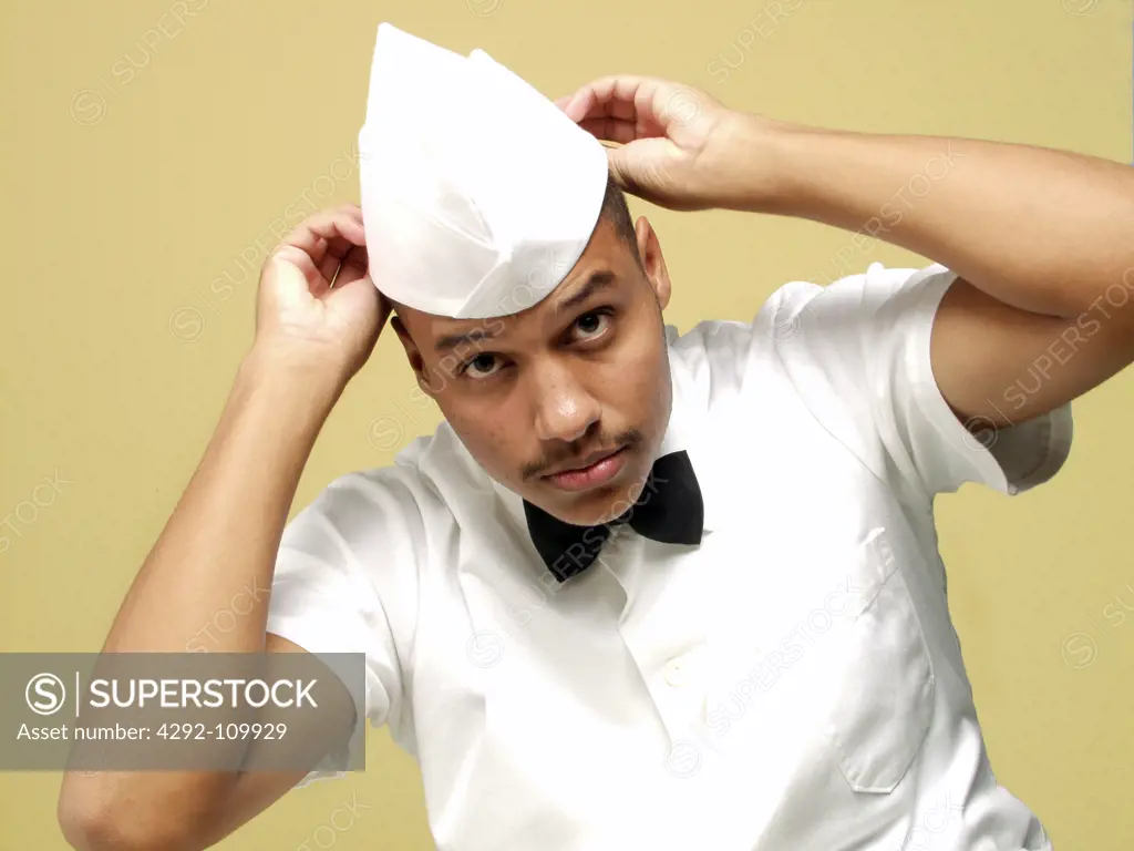 Waiter adjusting hat