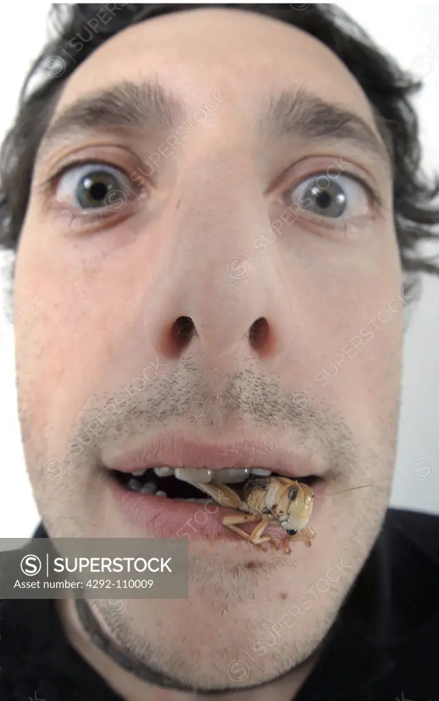 Man eating grasshopper