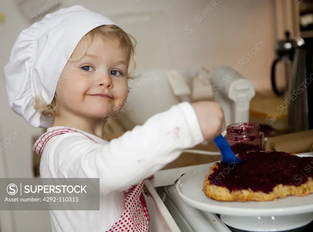 Girl spreading jam on bread