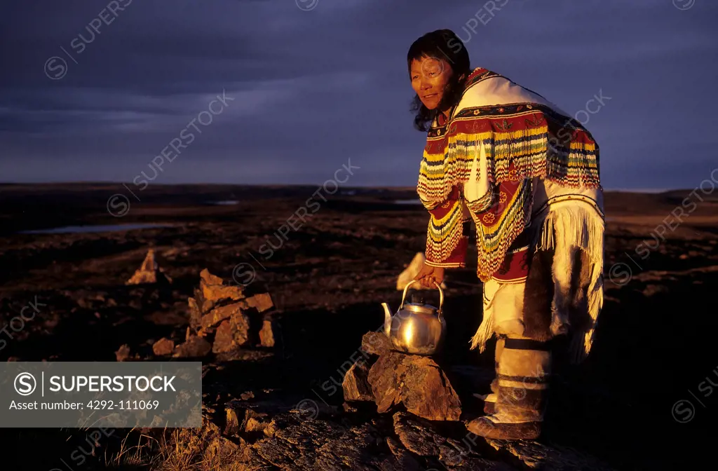 Canada, Baker Lake, Nanuvut, inuit woman cooking