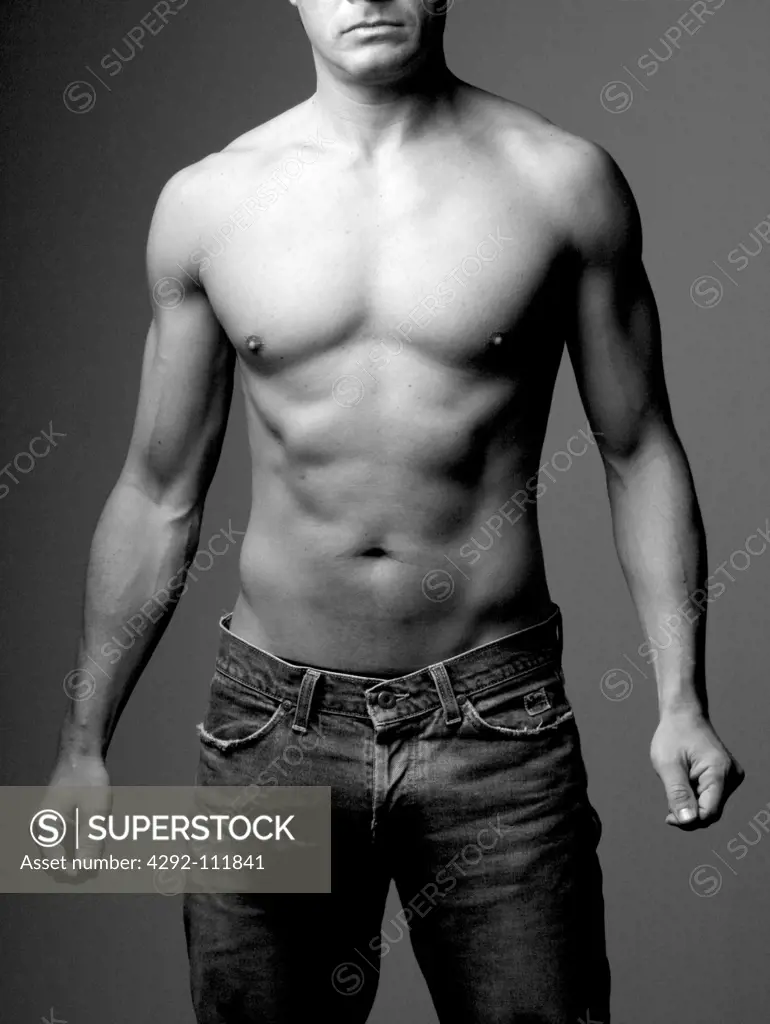 Naked man's chest wearing jeans