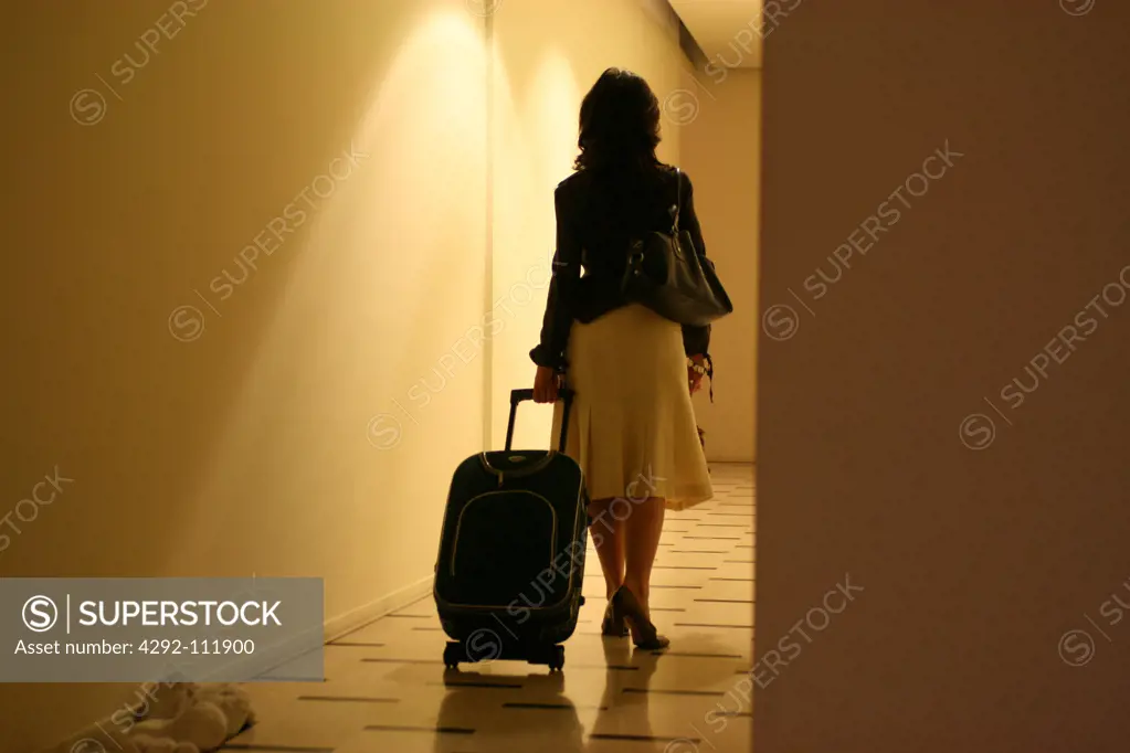 Woman pulling suitcase