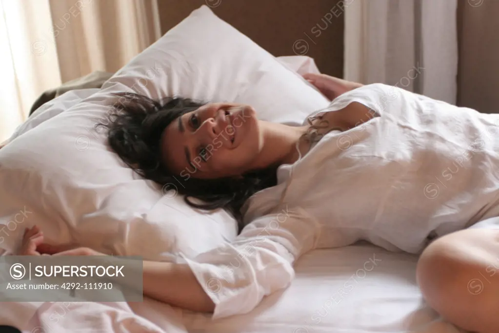 Woman in bed awaking