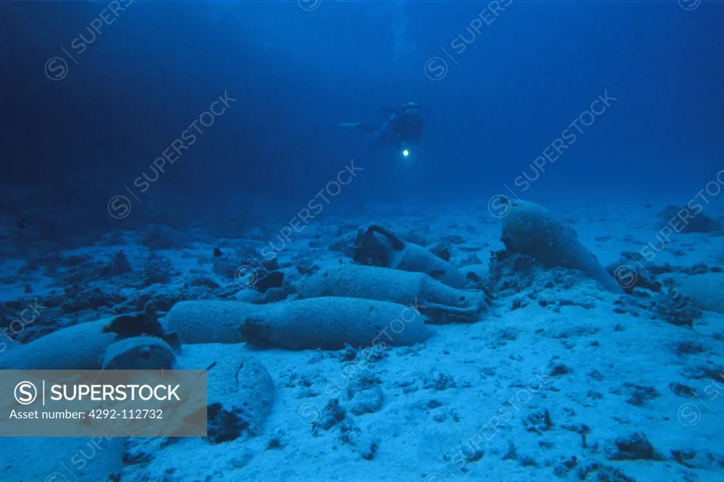 Egypt, Red sea. Scuba diver and roman amphoras