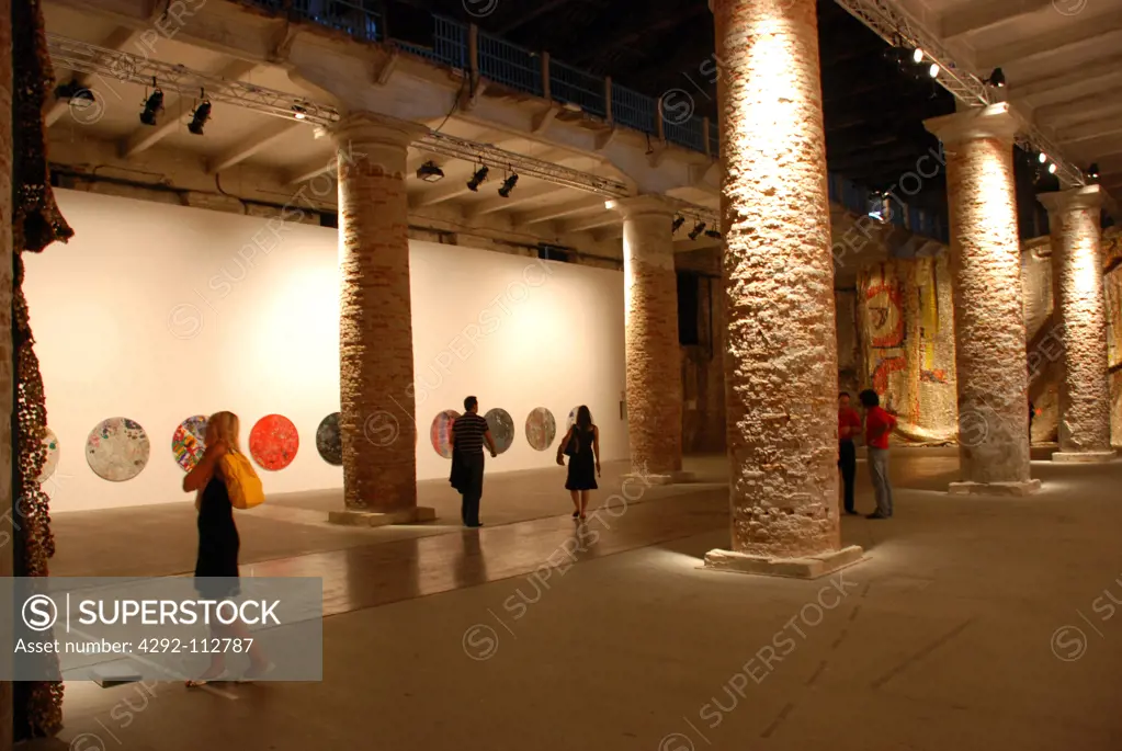 Italy, Veneto, Venice, A young woman viewing art in Arsenale at the Venice Biennale.