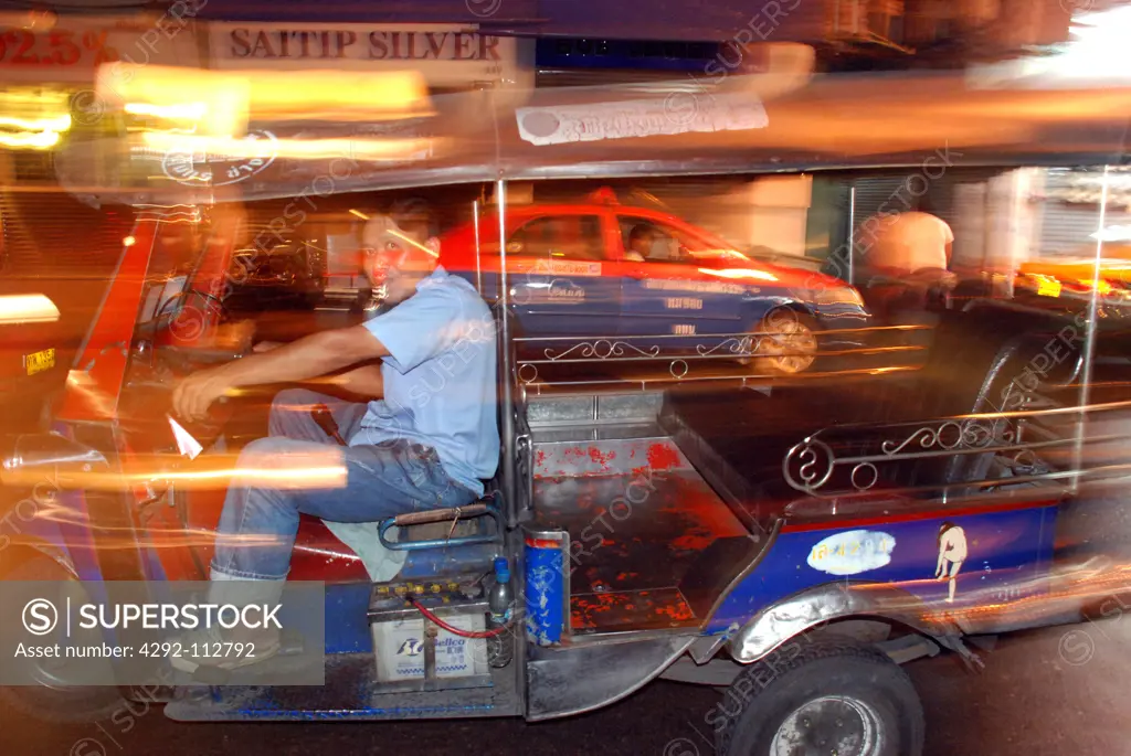 Thailand, Bangkok, Tuk Tuk Taxi Driver and his Tuk Tuk Driving.