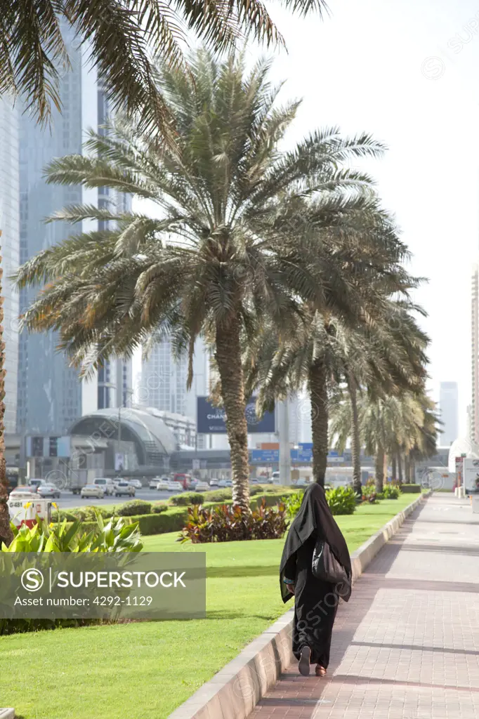 United Arab Emirates, Dubai, Arab Woman in a Hijab Walking in a City Street