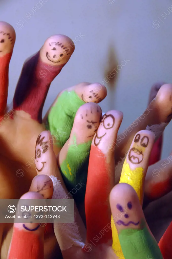 Faces drawn on coloured fingers