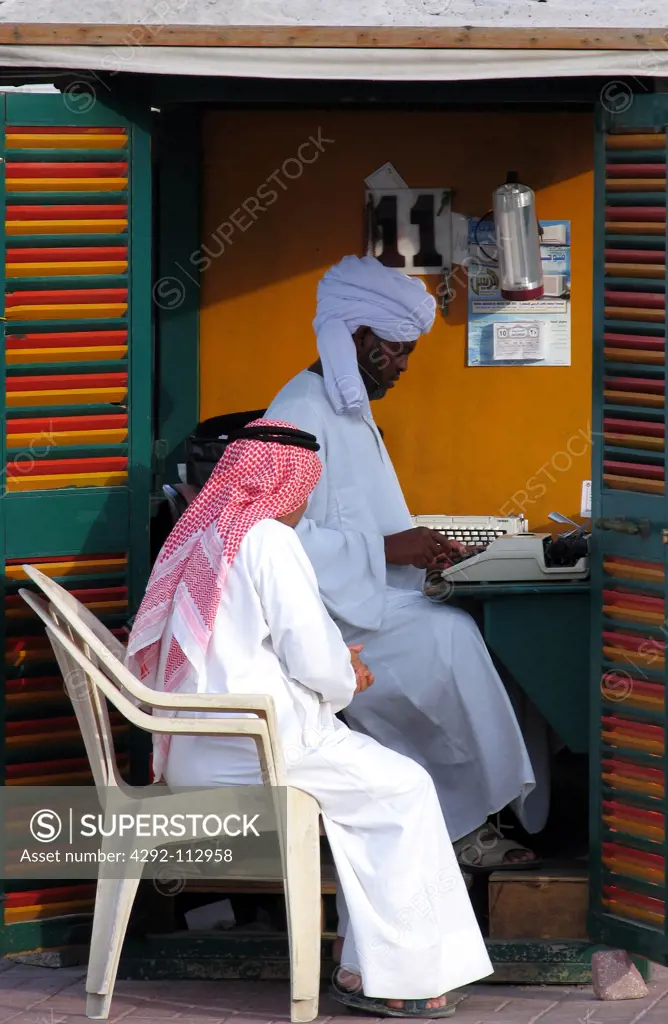 Qatar, Doha, a scribe with a client