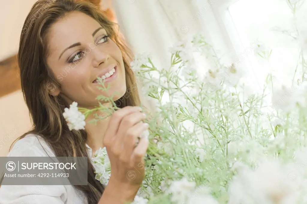 Woman at home looking at flowers