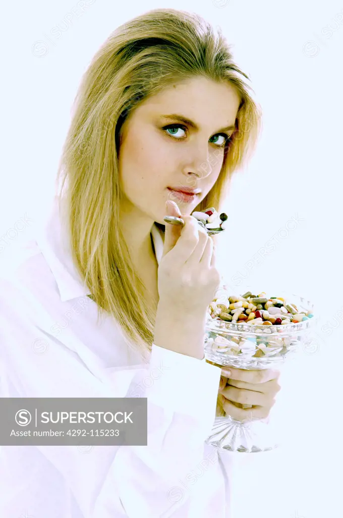 Woman with spoon of pills