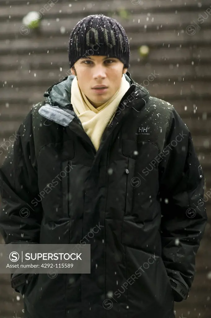 Portarit of a young man during a snowfall