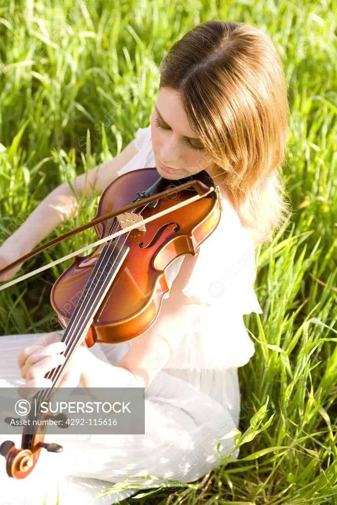 A young woman playing the violin outdoor