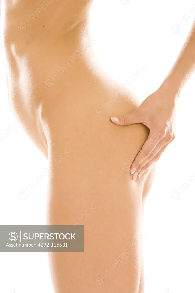 Naked woman pinching skin