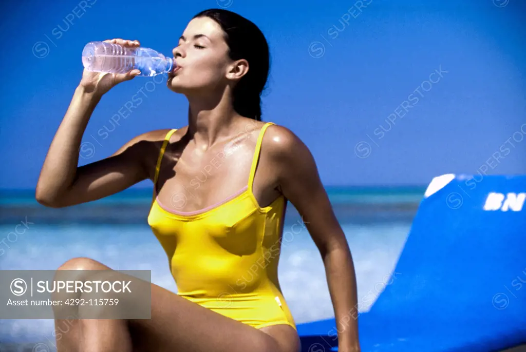 Woman at sea drinking water