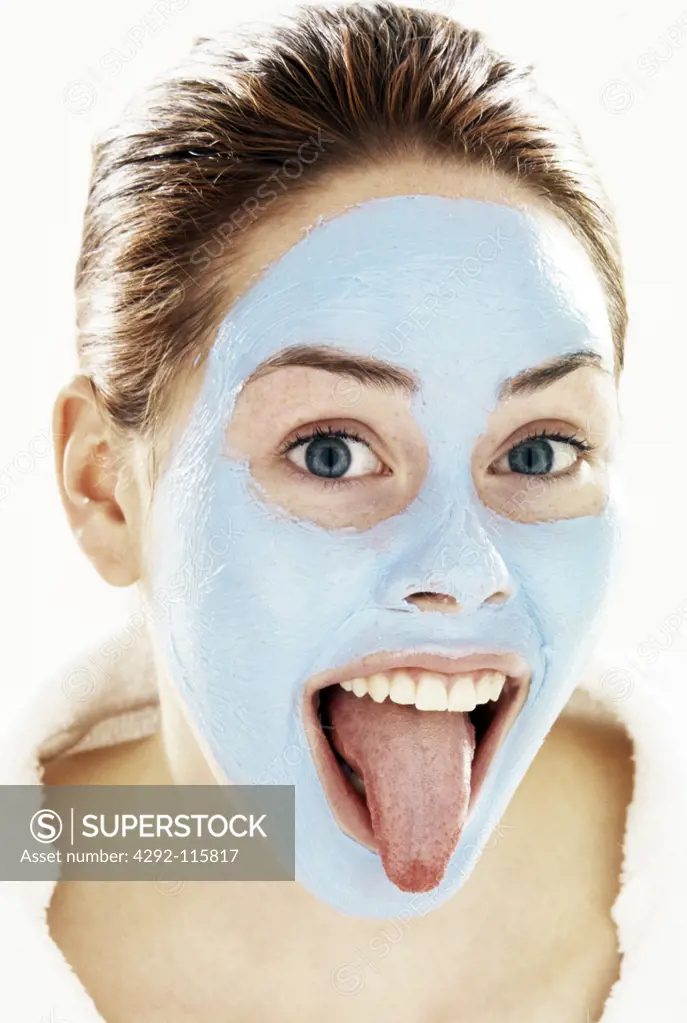 Woman's portrait with facial mask making faces