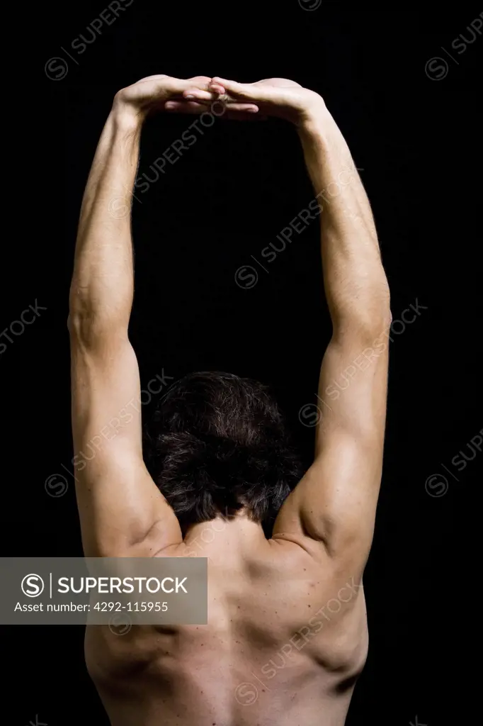Studio shot of a man stretching arms