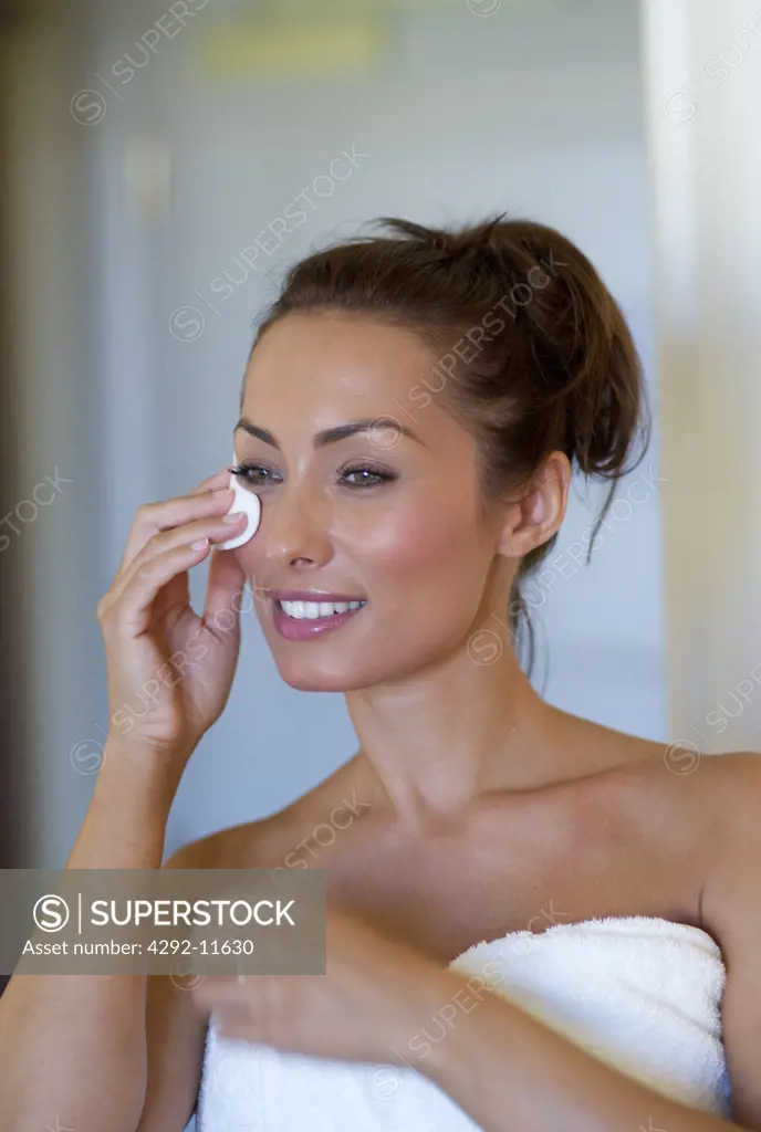 Young woman removing make up