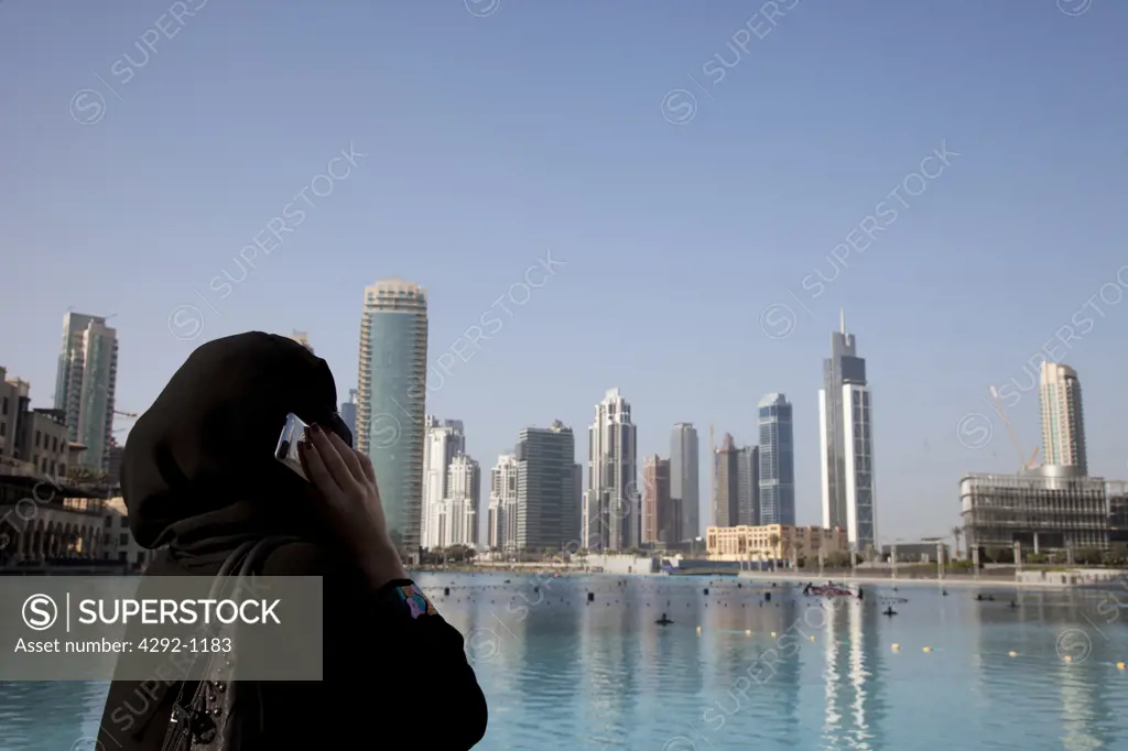 United Arab Emirates, Dubai, Arab Woman in a Hijab Using Cell Phone