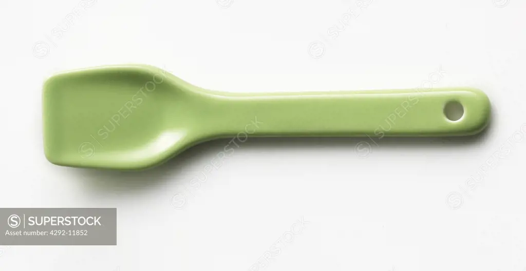 Plastic green spoon still life