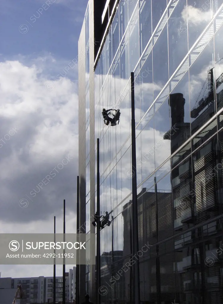 Ireland, Dublin, window washer in modern skyscrape