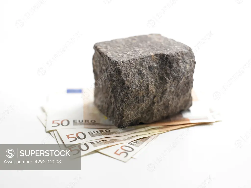 Stone with euro banknote