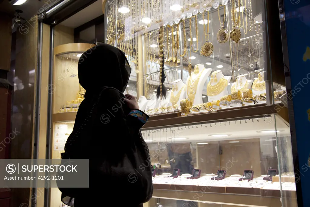 United Arab Emirates, Dubai, Arab Woman in a Hijab Looking at Display Window of Jewelery