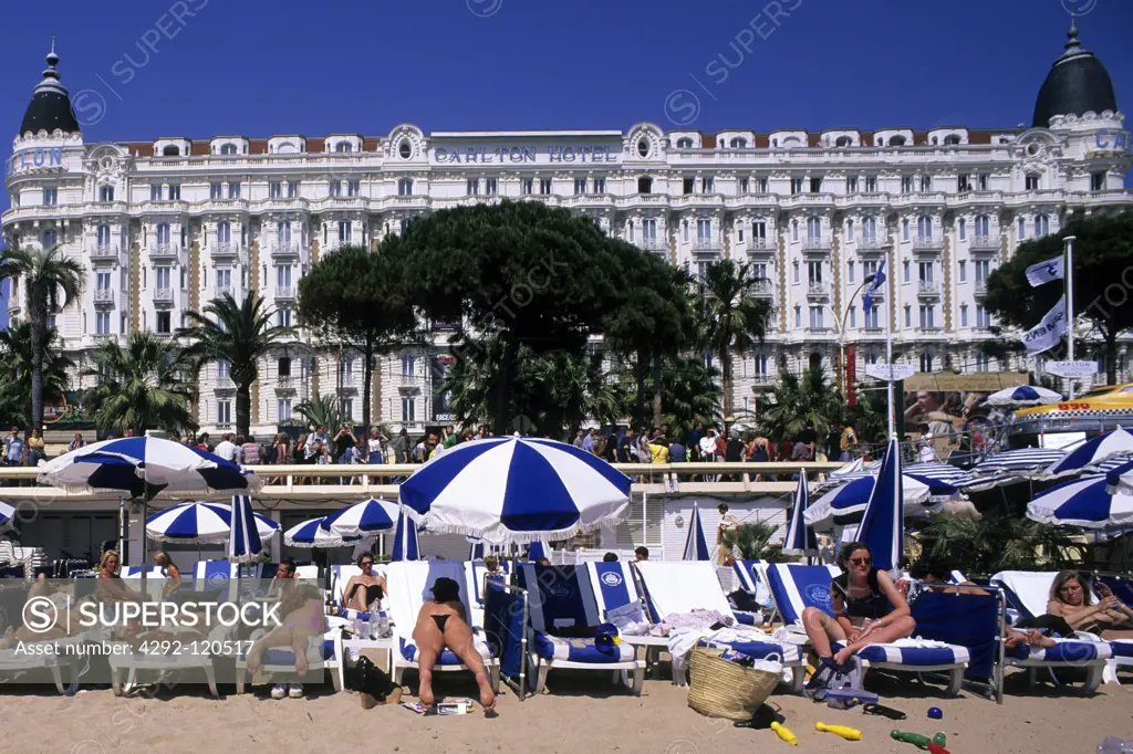France, Provence, Cote d'Azur, Cannes, hotel and crowded beach with La Croisette