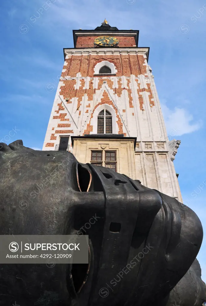 Poland, Krakow, Old Town, Rynek Glowny, Eros sculpture from Igor Mitoraj with Town Hall tower in the backround