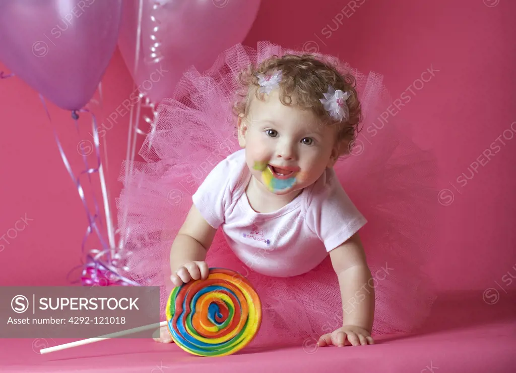 Studio shot of a girl with lollipop