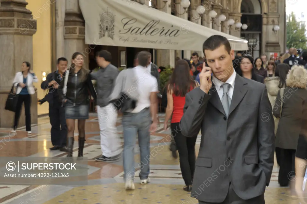 Italy, Lombardy, Milan,Vittorio Emanuele Gallery . Businessman in Duomo square using mobile