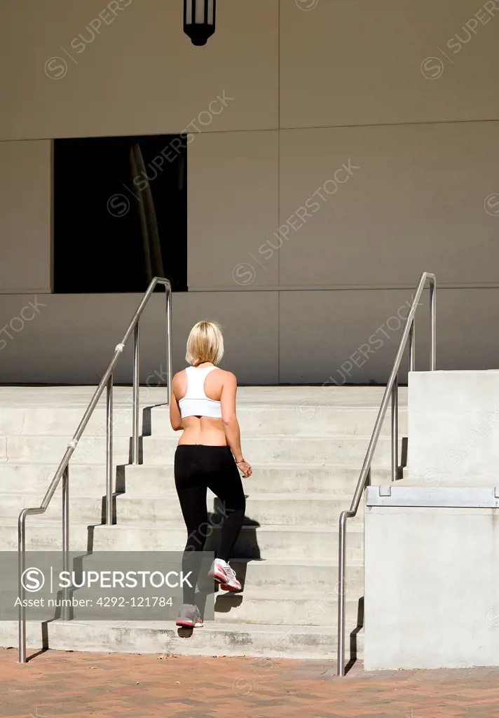 woman jogging upstairs