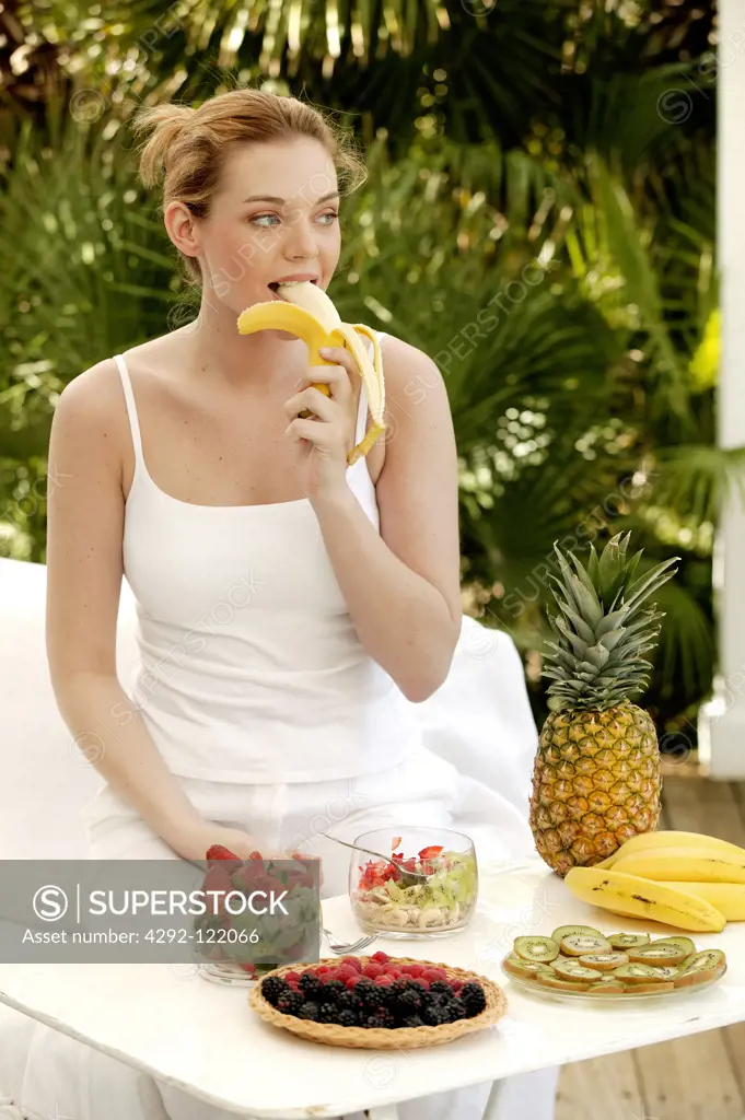 Young woman eating fruits