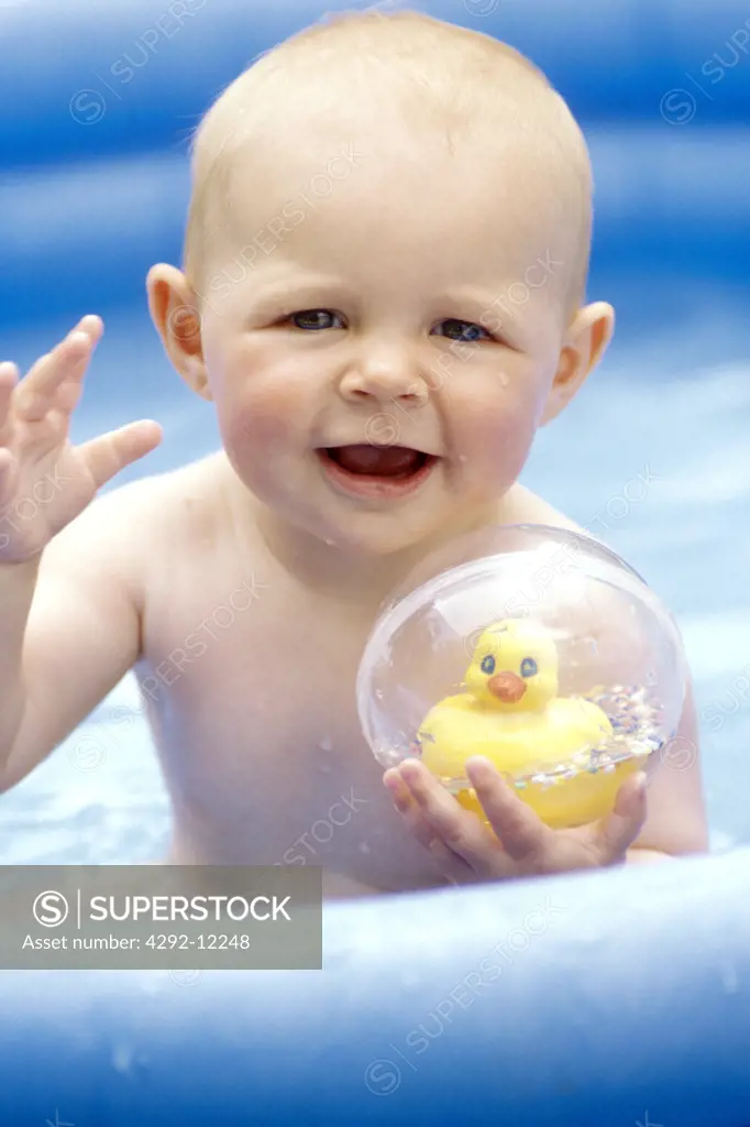 Baby playing in rubber swimming pool