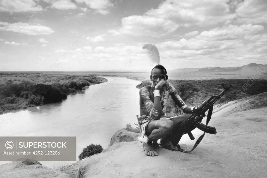 Africa, Ethiopia, South Omo, Mago National Park, Mursi man with body painting and AK47 rifle