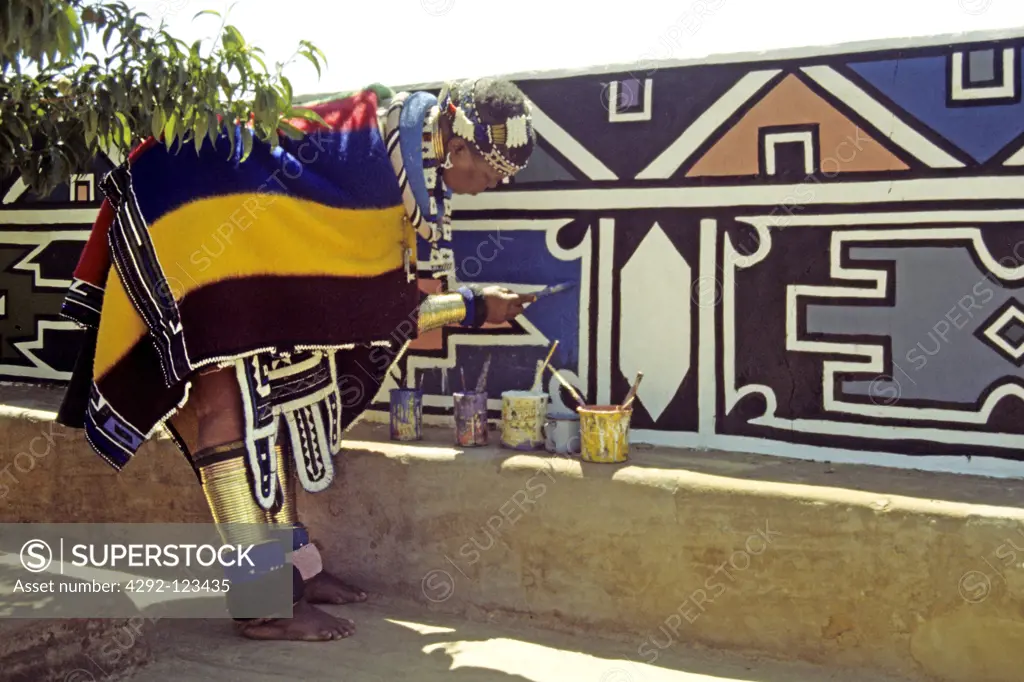 South Africa, Ndebele, woman painting the wall of her home