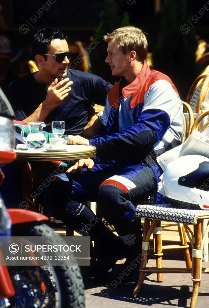 Two men sitting in cafe outdoor